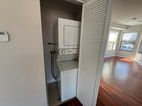 a view of hallway with stairs and wooden floor