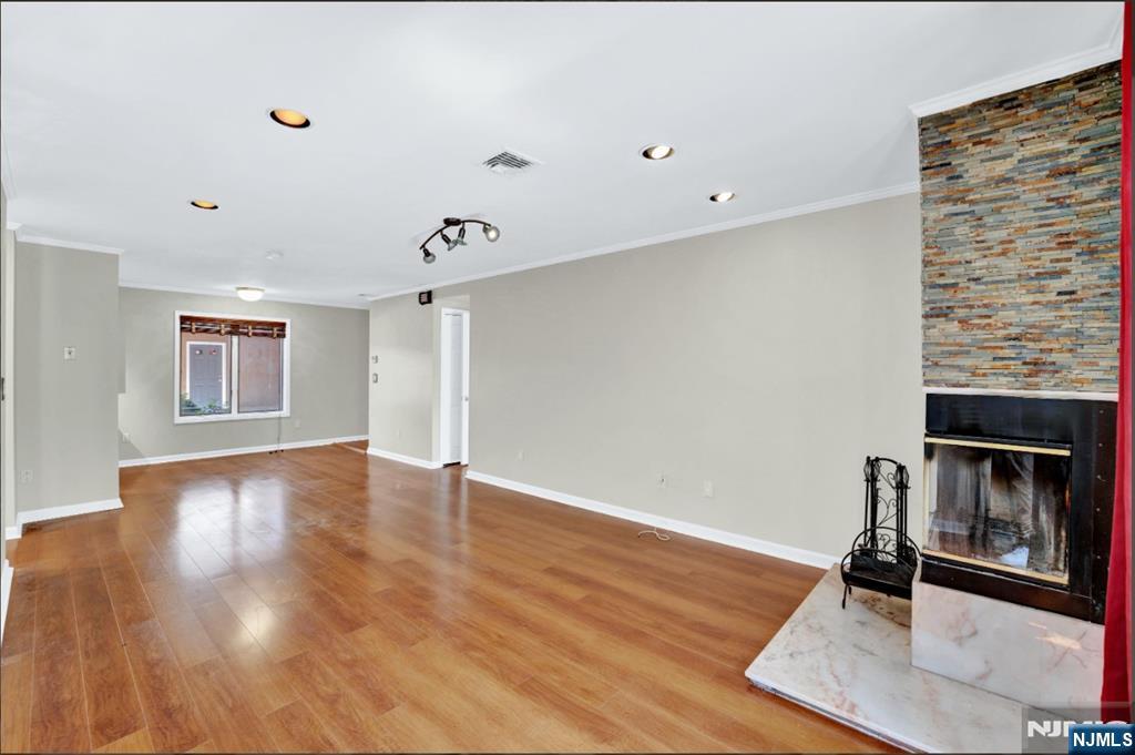 105 State Street, Unit 1B Hackensack, NJ 07601 - Photo 13 of 22 a view of a livingroom with wooden floor and a ceiling fan