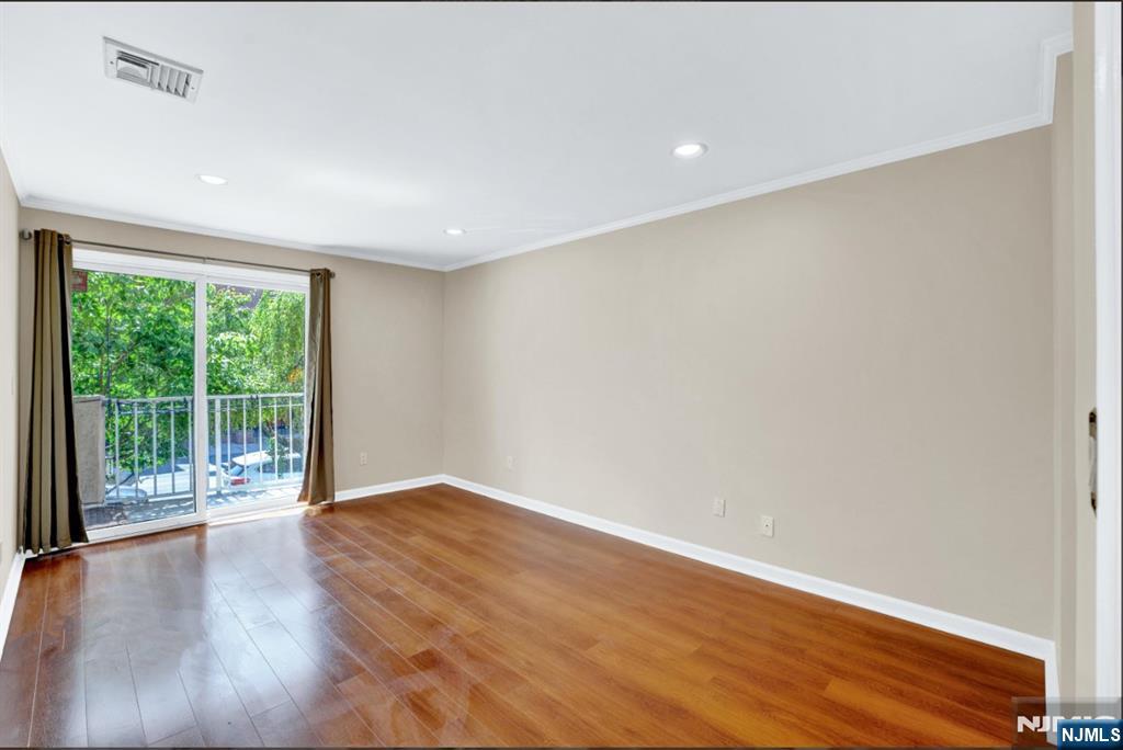 105 State Street, Unit 1B Hackensack, NJ 07601 - Photo 15 of 22 a view of an empty room with wooden floor and a window