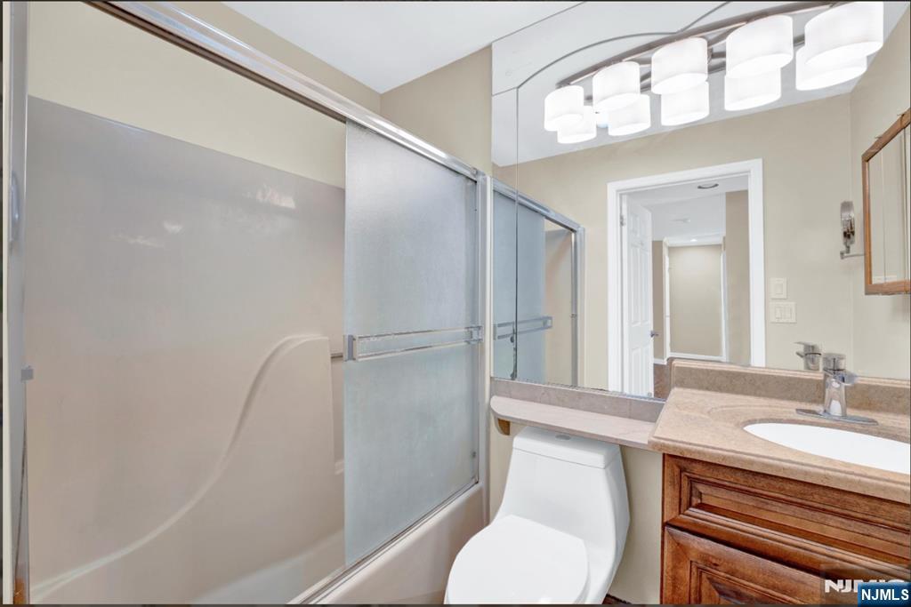 105 State Street, Unit 1B Hackensack, NJ 07601 - Photo 19 of 22 a bathroom with a sink a toilet a mirror and shower