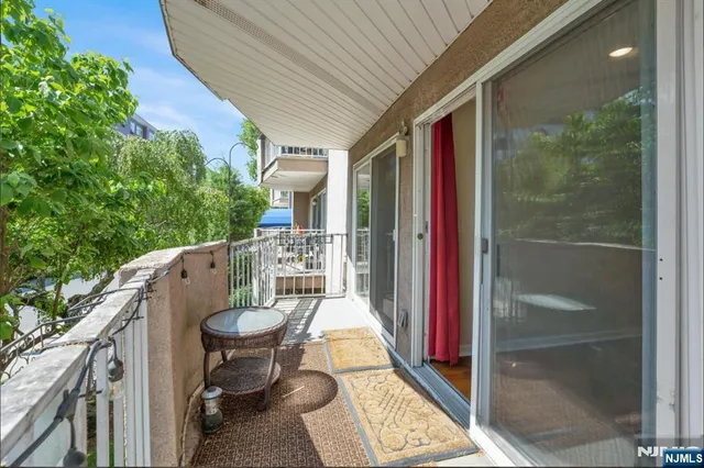 a balcony view with a seating space