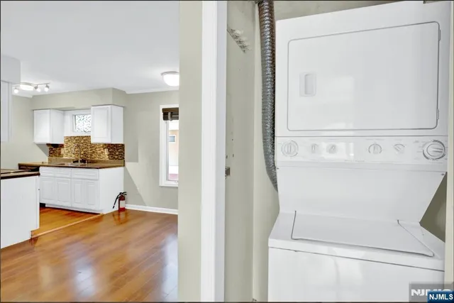 a view of kitchen with wooden floor and electronic appliances