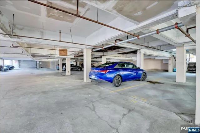 a view of parking garage with cars parked