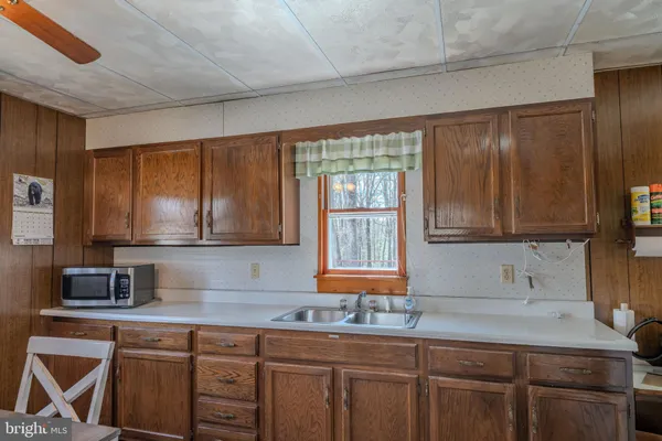 a kitchen with granite countertop a sink and a stove
