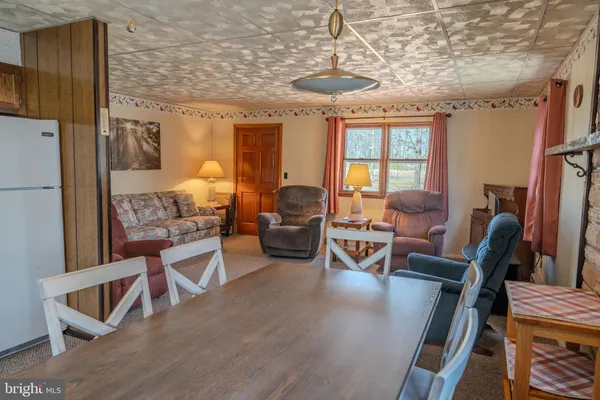 a living room with furniture a table and chairs