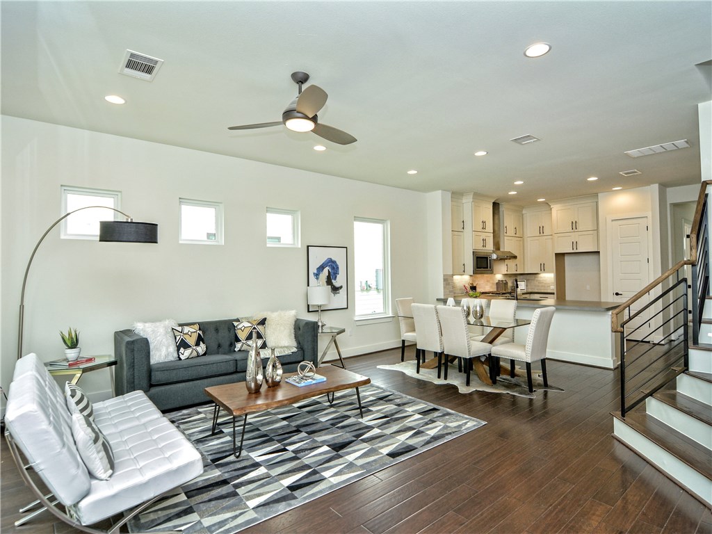 a living room with furniture and kitchen view