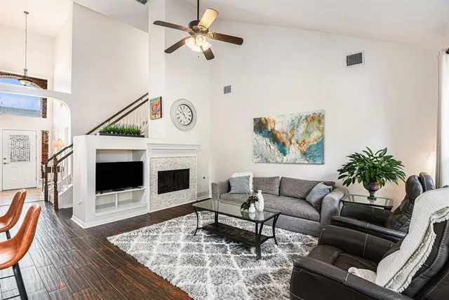 a living room with furniture a fireplace and a flat screen tv