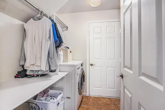 a bedroom with a bed flat screen tv and a large window