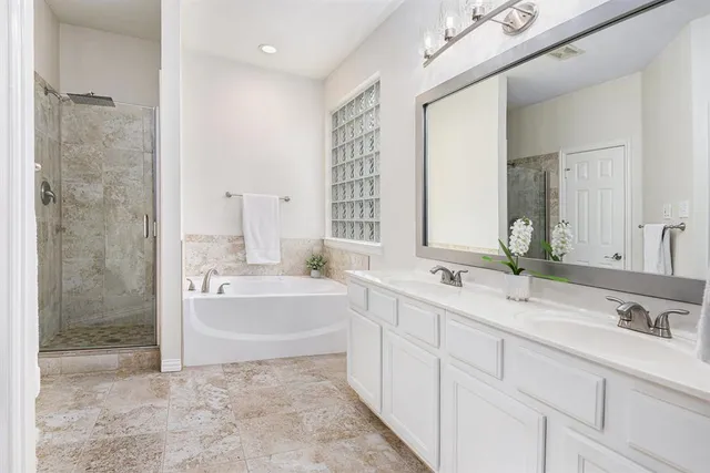 a bathroom with a bathtub and shower