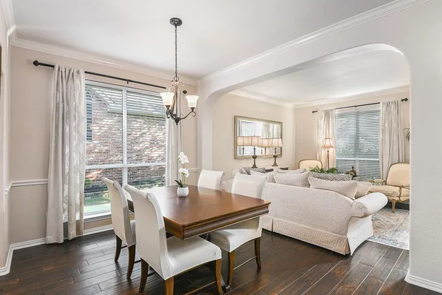 a living room with furniture a table and a large window