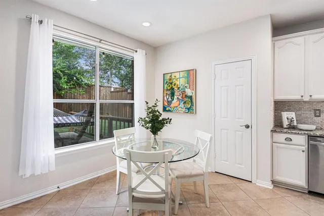 a dining room with furniture and window