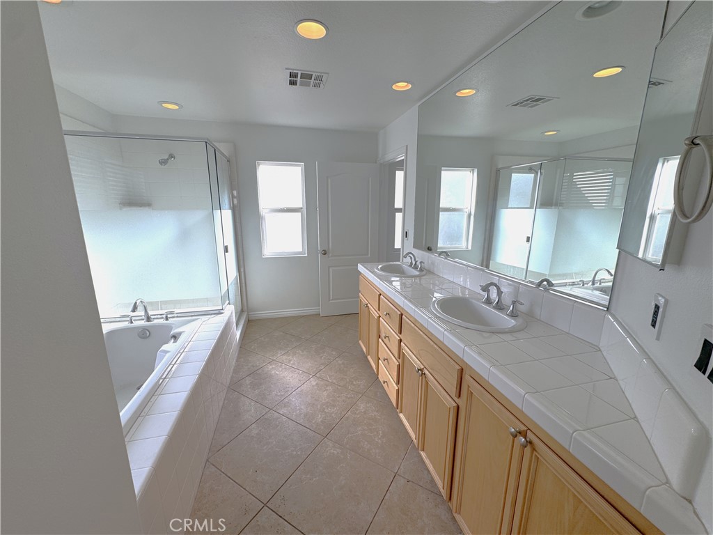 8240 Chamberlain Lane Reseda, CA 91335 - Photo 17 of 23 a bathroom with a granite countertop sink a mirror and a bathtub