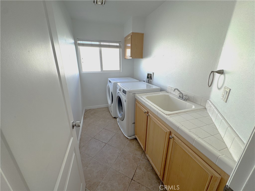8240 Chamberlain Lane Reseda, CA 91335 - Photo 18 of 23 a utility room with dryer and washer