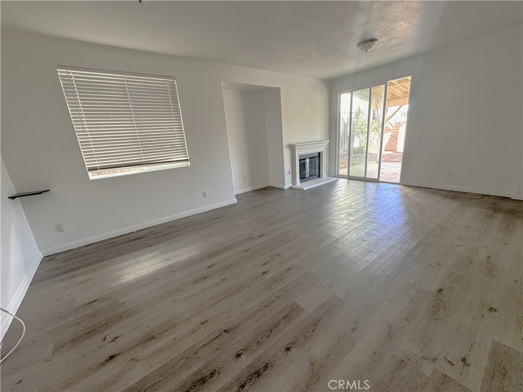 8240 Chamberlain Lane Reseda, CA 91335 - Photo 5 of 23 a view of an empty room with wooden floor and a window