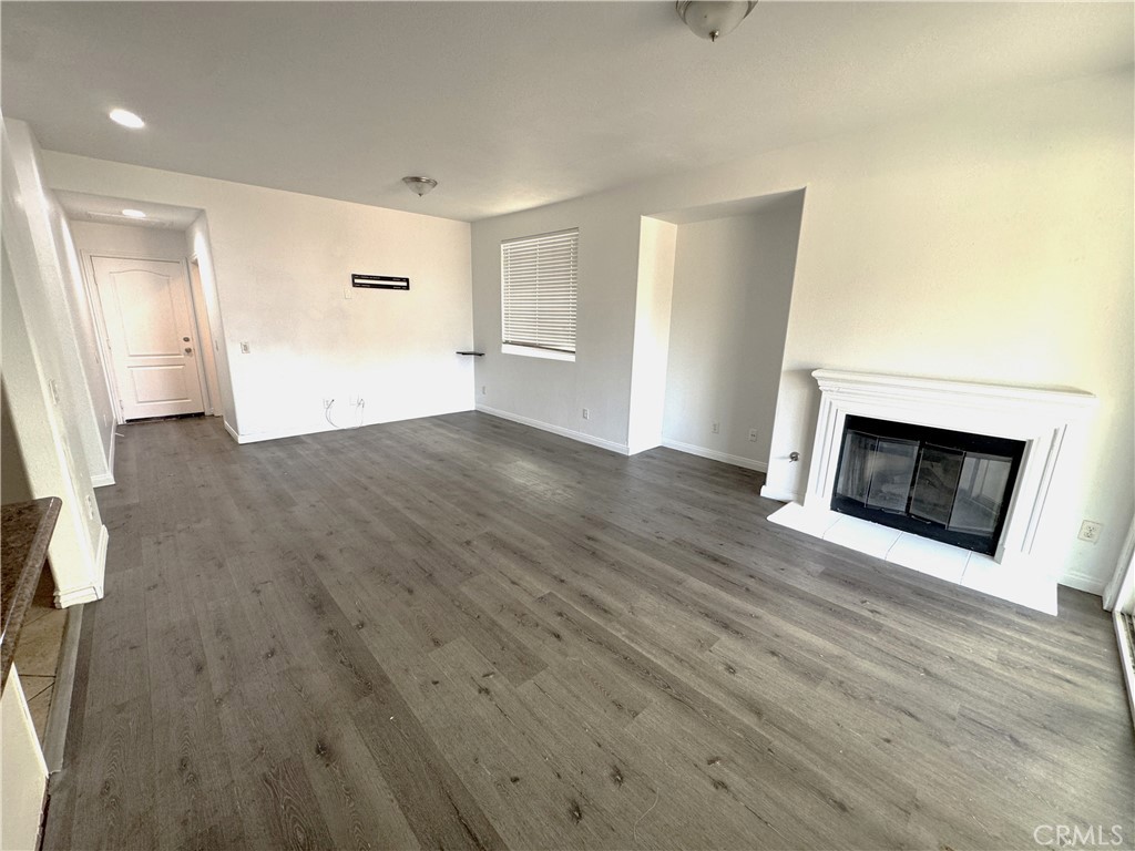 8240 Chamberlain Lane Reseda, CA 91335 - Photo 7 of 23 a view of a livingroom with wooden floor and a fireplace
