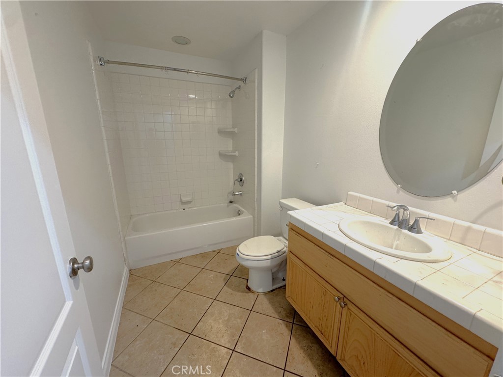 8240 Chamberlain Lane Reseda, CA 91335 - Photo 10 of 23 a bathroom with a granite countertop sink toilet a mirror and shower