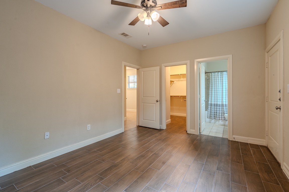 5213 Eigel Street, Unit B Houston, TX 77007 - Photo 26 of 28 an empty room with wooden floor and windows