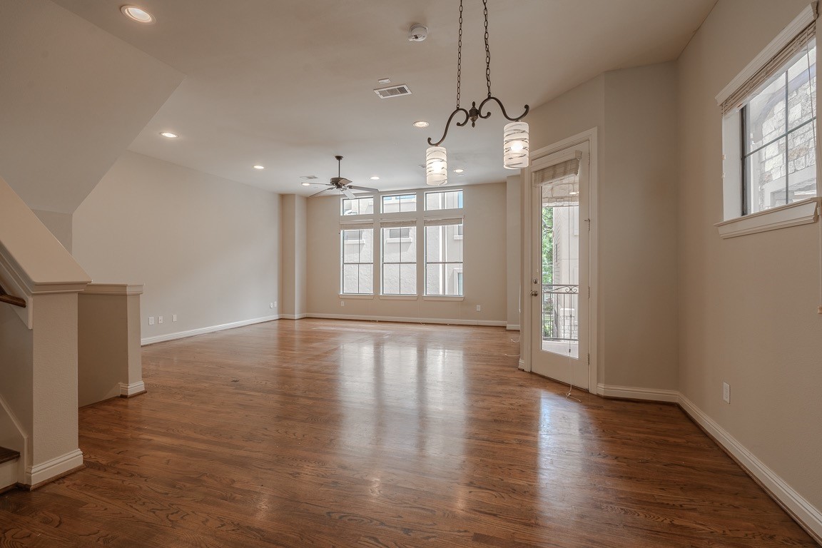 5213 Eigel Street, Unit B Houston, TX 77007 - Photo 4 of 28 an empty room with wooden floor and windows