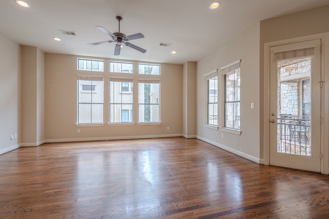 5213 Eigel Street, Unit B Houston, TX 77007 - Photo 6 of 28 a view of an empty room with wooden floor and a window