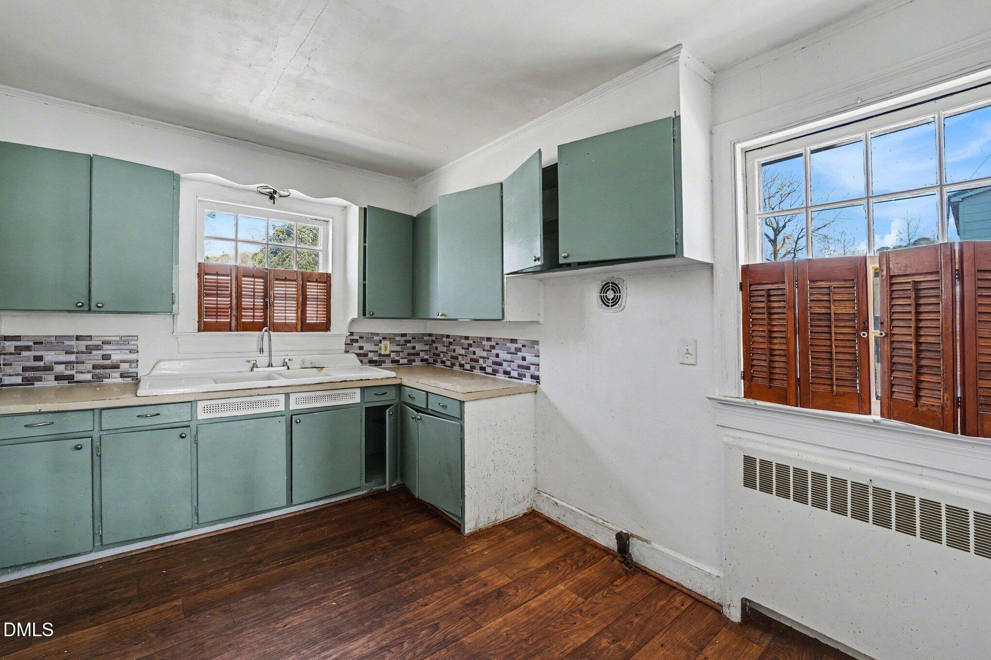 300 Frances Place Kinston, NC 28501 - Photo 12 of 25 a kitchen with a sink cabinets and wooden floor