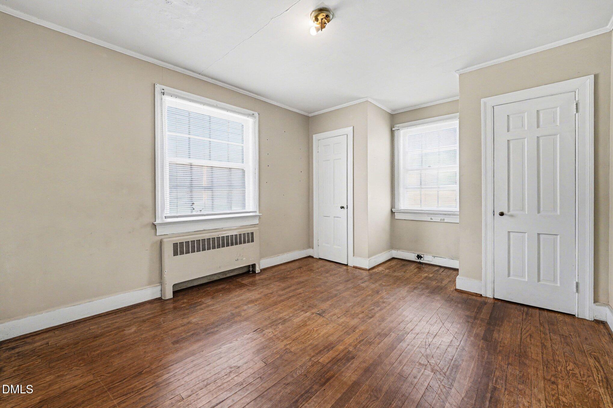 300 Frances Place Kinston, NC 28501 - Photo 18 of 25 an empty room with wooden floor and windows