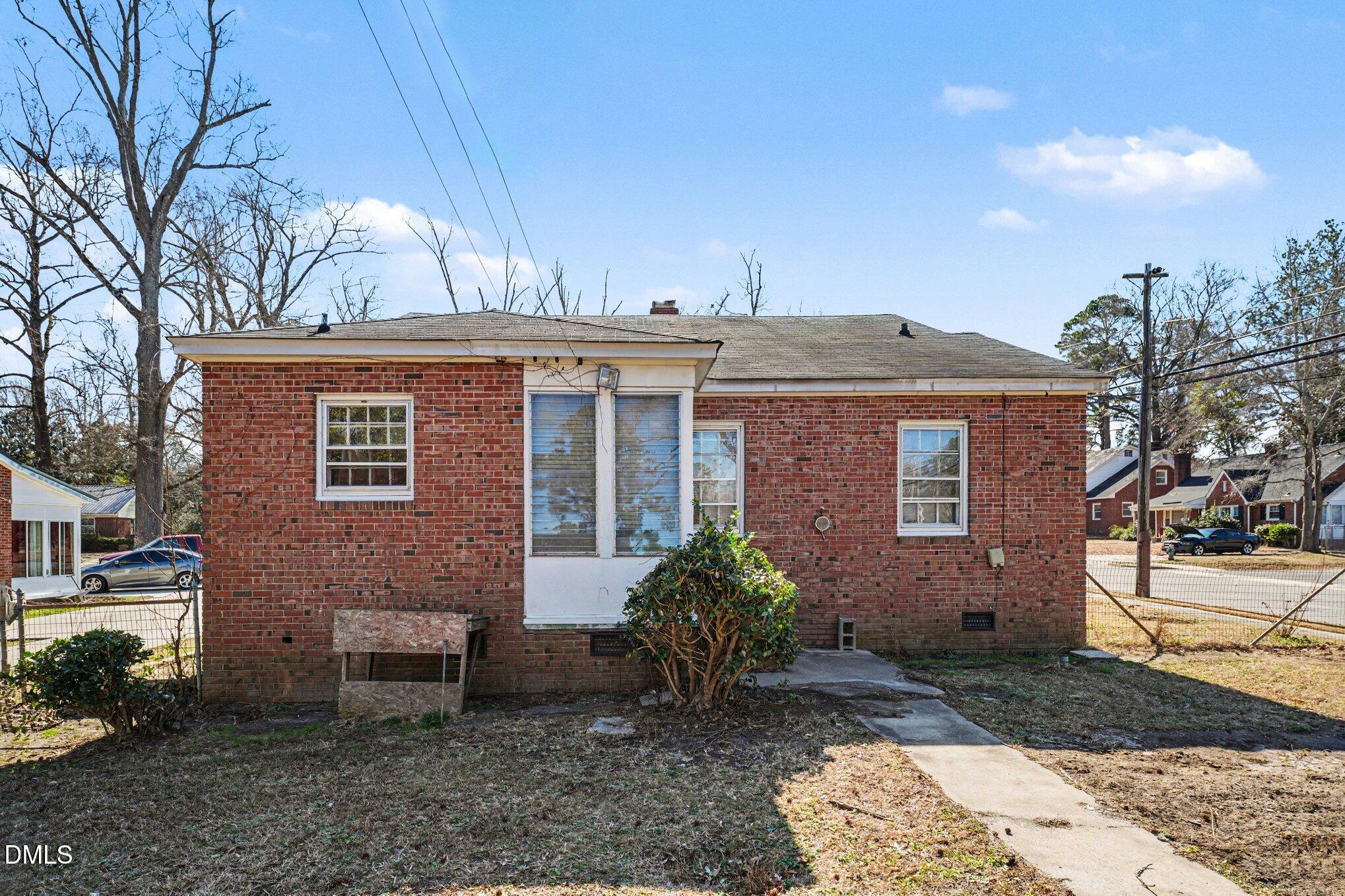 300 Frances Place Kinston, NC 28501 - Photo 22 of 25 a view of a brick house with a yard and large tree
