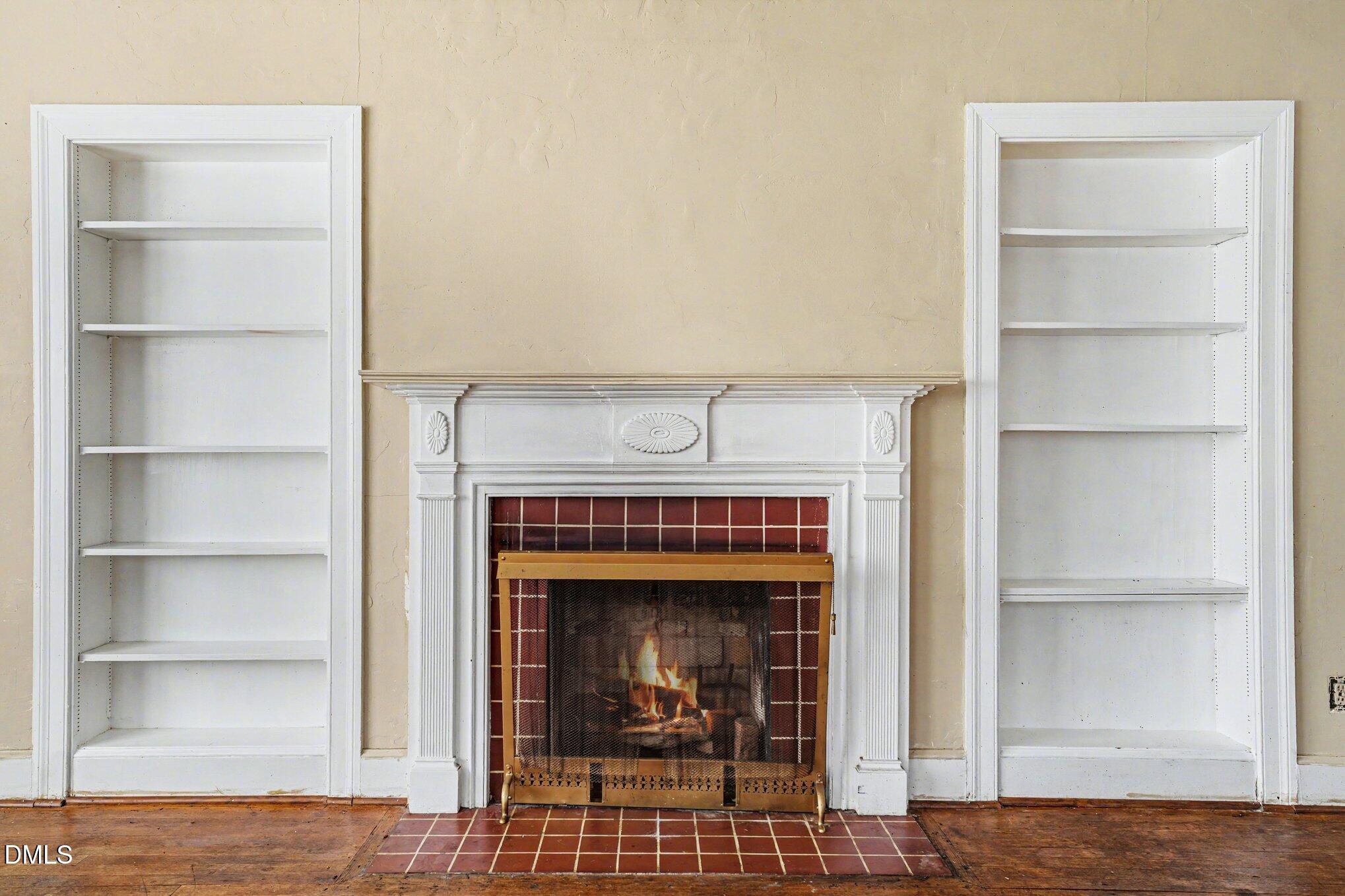 300 Frances Place Kinston, NC 28501 - Photo 8 of 25 a living room with a fireplace and a book shelf