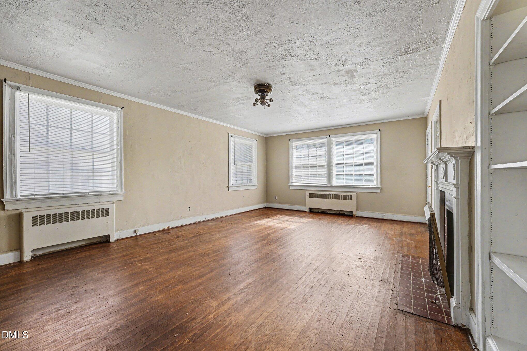 300 Frances Place Kinston, NC 28501 - Photo 9 of 25 an empty room with wooden floor and windows