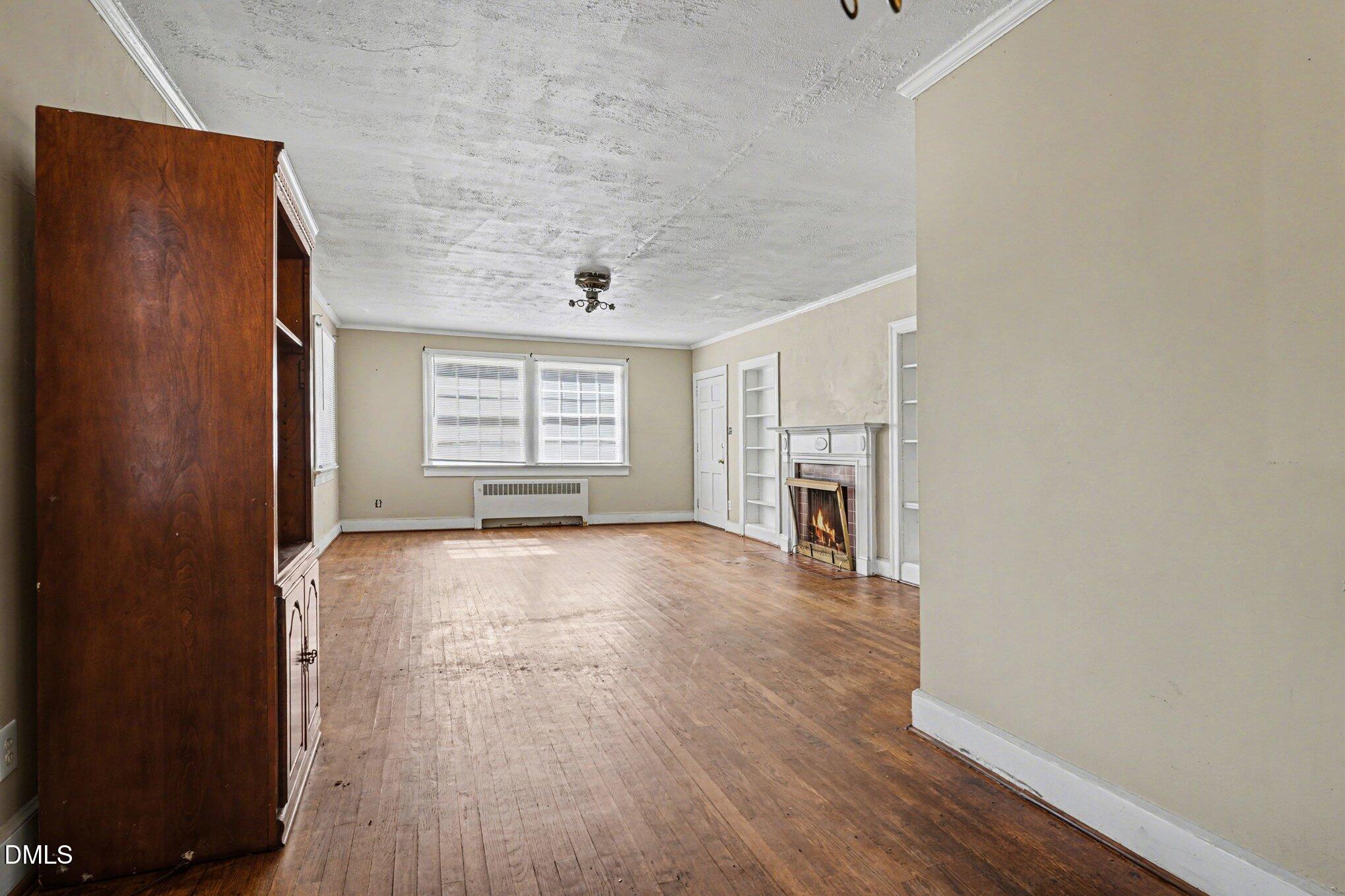 300 Frances Place Kinston, NC 28501 - Photo 10 of 25 an empty room with wooden floor and windows