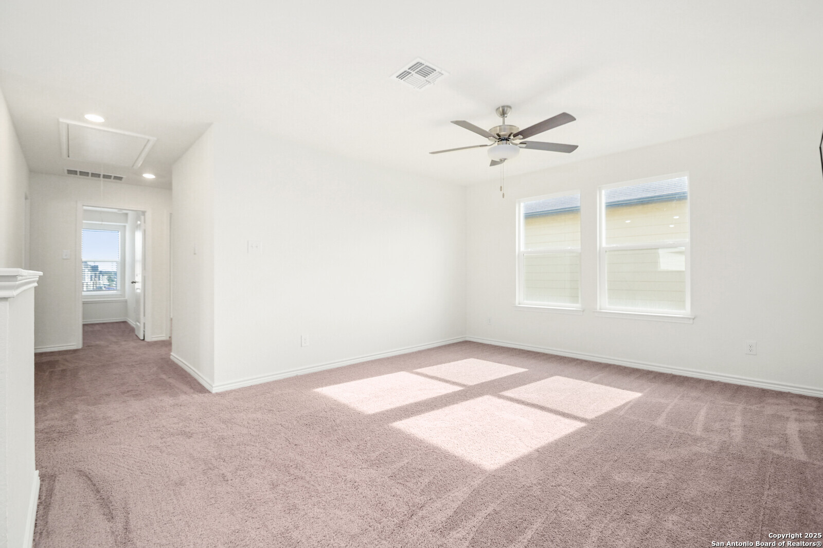 5010 Big Oak Run Elmendorf, TX 78112 - Photo 14 of 31 an empty room with chandelier fan and windows