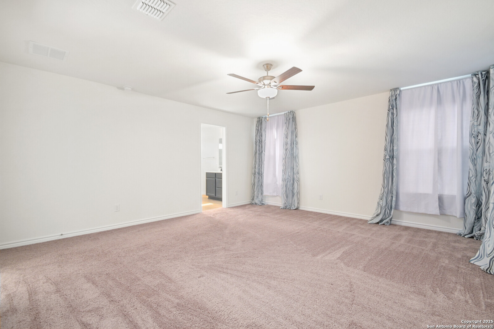 5010 Big Oak Run Elmendorf, TX 78112 - Photo 17 of 31 an empty room with a ceiling fan and a window