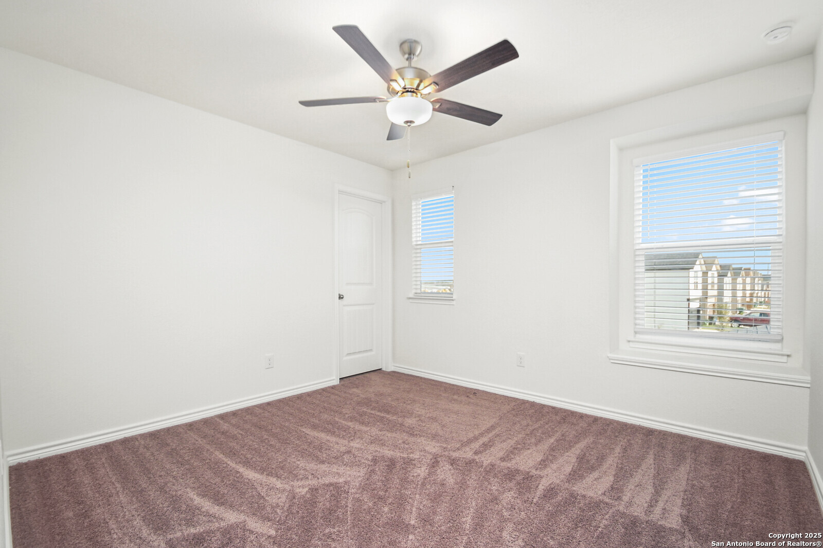 5010 Big Oak Run Elmendorf, TX 78112 - Photo 20 of 31 an empty room with a window and a ceiling fan