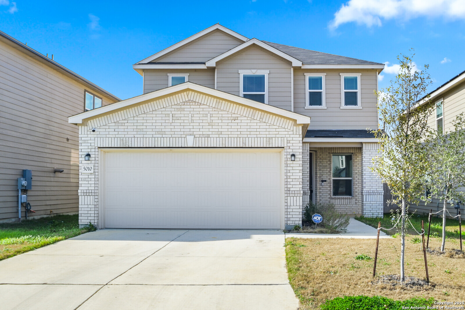 5010 Big Oak Run Elmendorf, TX 78112 - Photo 2 of 31 a front view of a house with a yard and garage