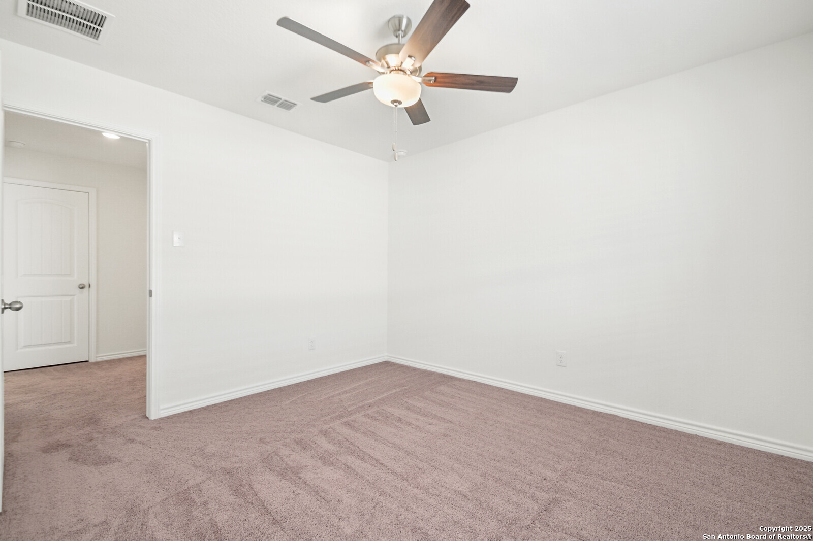 5010 Big Oak Run Elmendorf, TX 78112 - Photo 26 of 31 an empty room with a fan and a ceiling fan