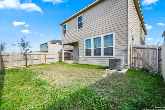 a view of an house with backyard space and sitting area