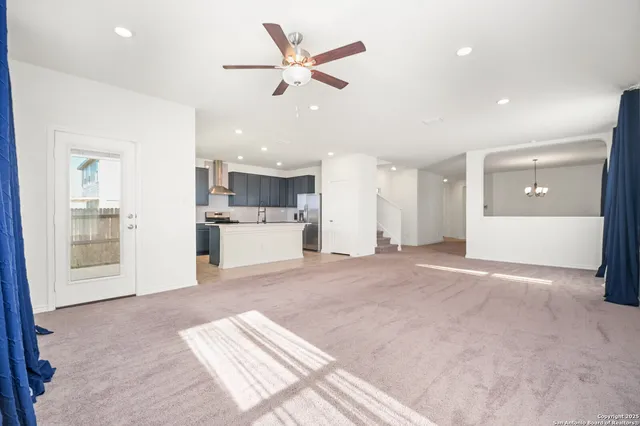 a view of a kitchen with a sink and a refrigerator