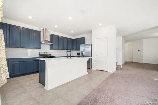 a kitchen with refrigerator cabinets and a sink