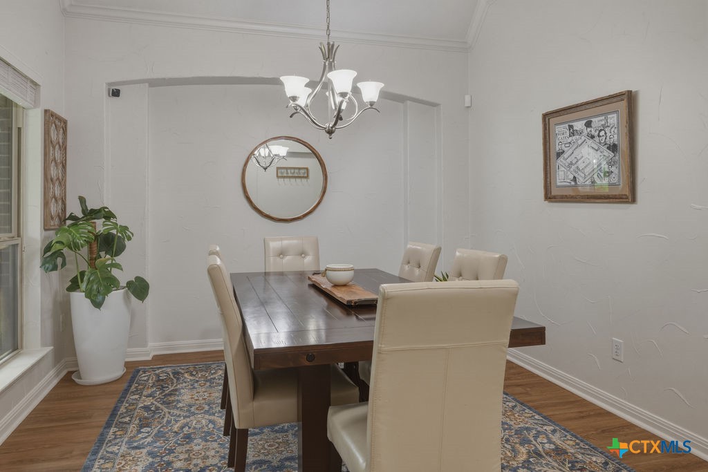 3306 Spring Canyon Road Belton, TX 76513 - Photo 15 of 40 a view of a dining room with furniture and chandelier