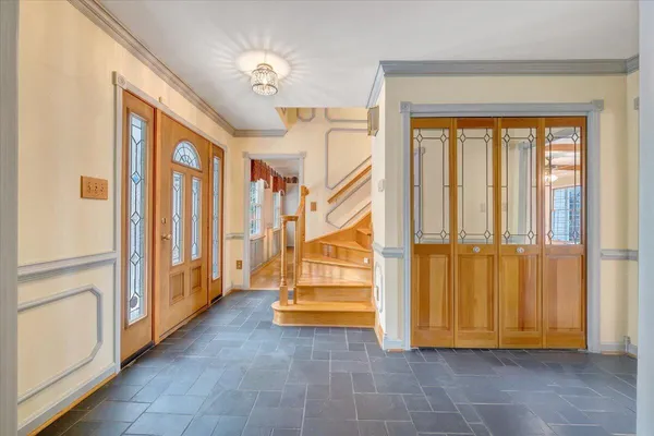 a view of an empty room with window and a swimming pool