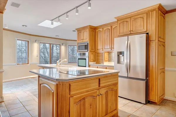 a kitchen with stainless steel appliances granite countertop a refrigerator and a sink