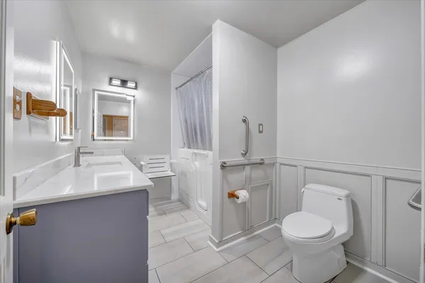 a bathroom with a sink a vanity and a mirror