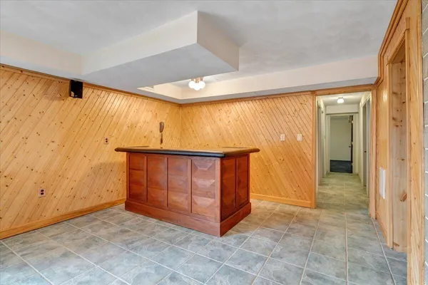 a bathroom with a tub a sink and a mirror