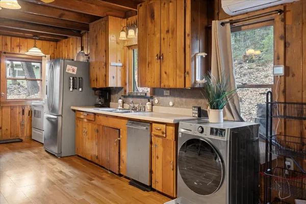 a living room with furniture a fireplace and a large window