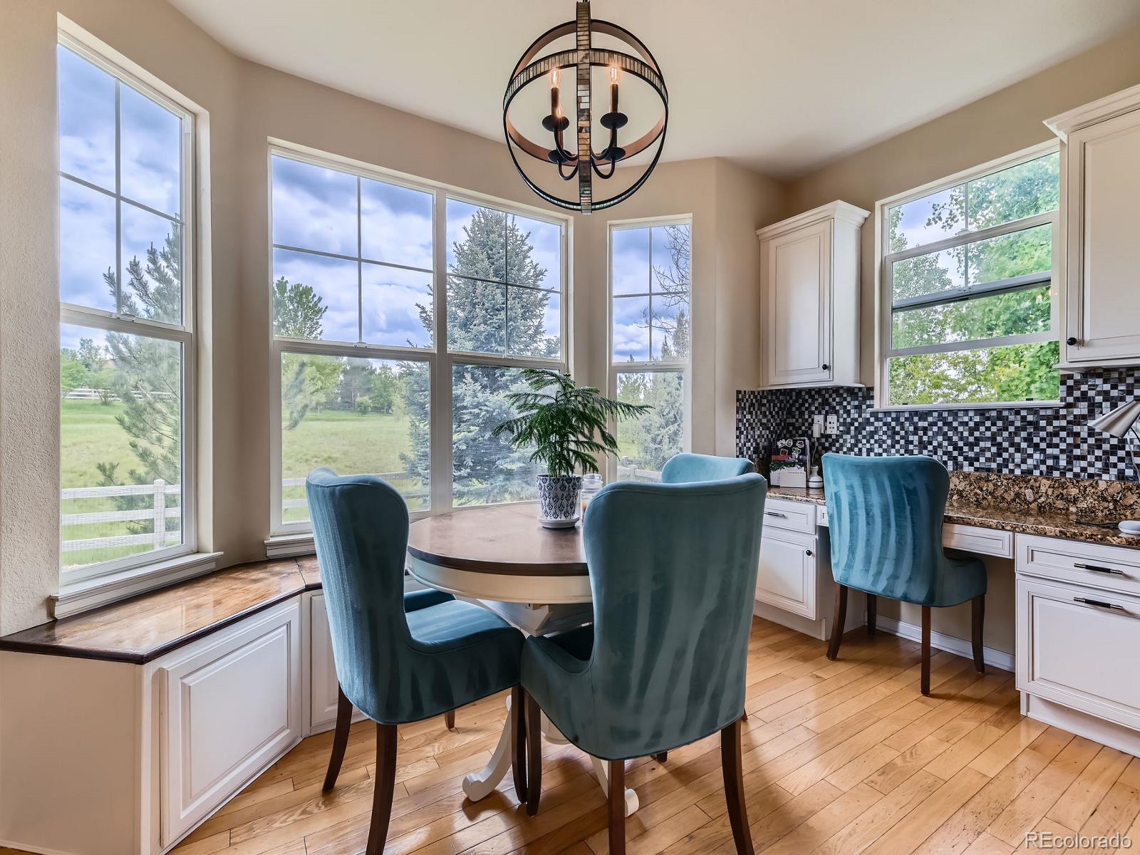 2896 Gemini Loop Broomfield, CO 80023 - Photo 11 of 49 a dining room with furniture a chandelier and wooden floor