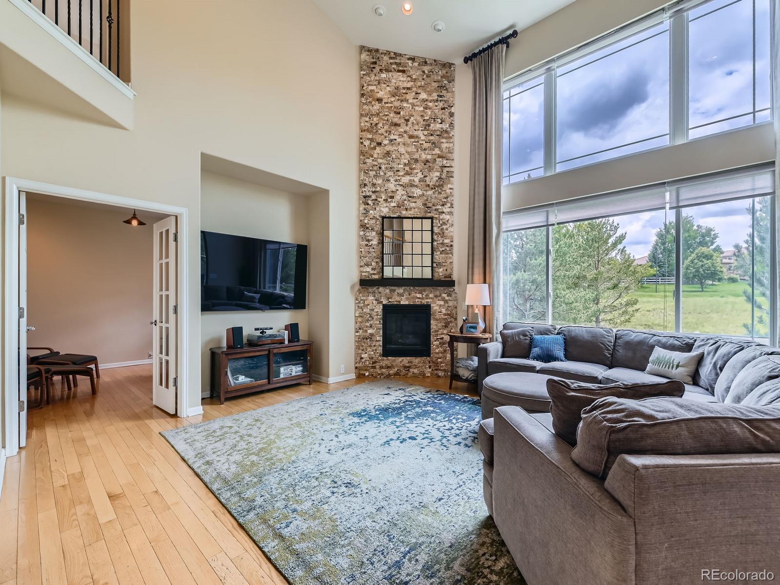 2896 Gemini Loop Broomfield, CO 80023 - Photo 13 of 49 a living room with fireplace furniture and a flat screen tv