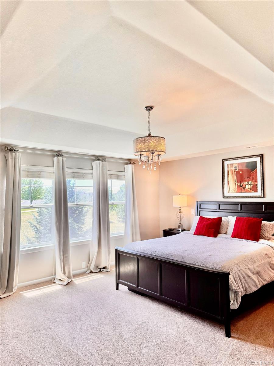 2896 Gemini Loop Broomfield, CO 80023 - Photo 20 of 49 a bedroom with a bed lamps and window