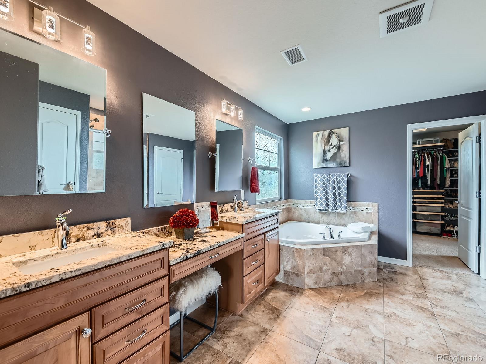 2896 Gemini Loop Broomfield, CO 80023 - Photo 22 of 49 a spacious bathroom with a double vanity sink mirror and bathtub