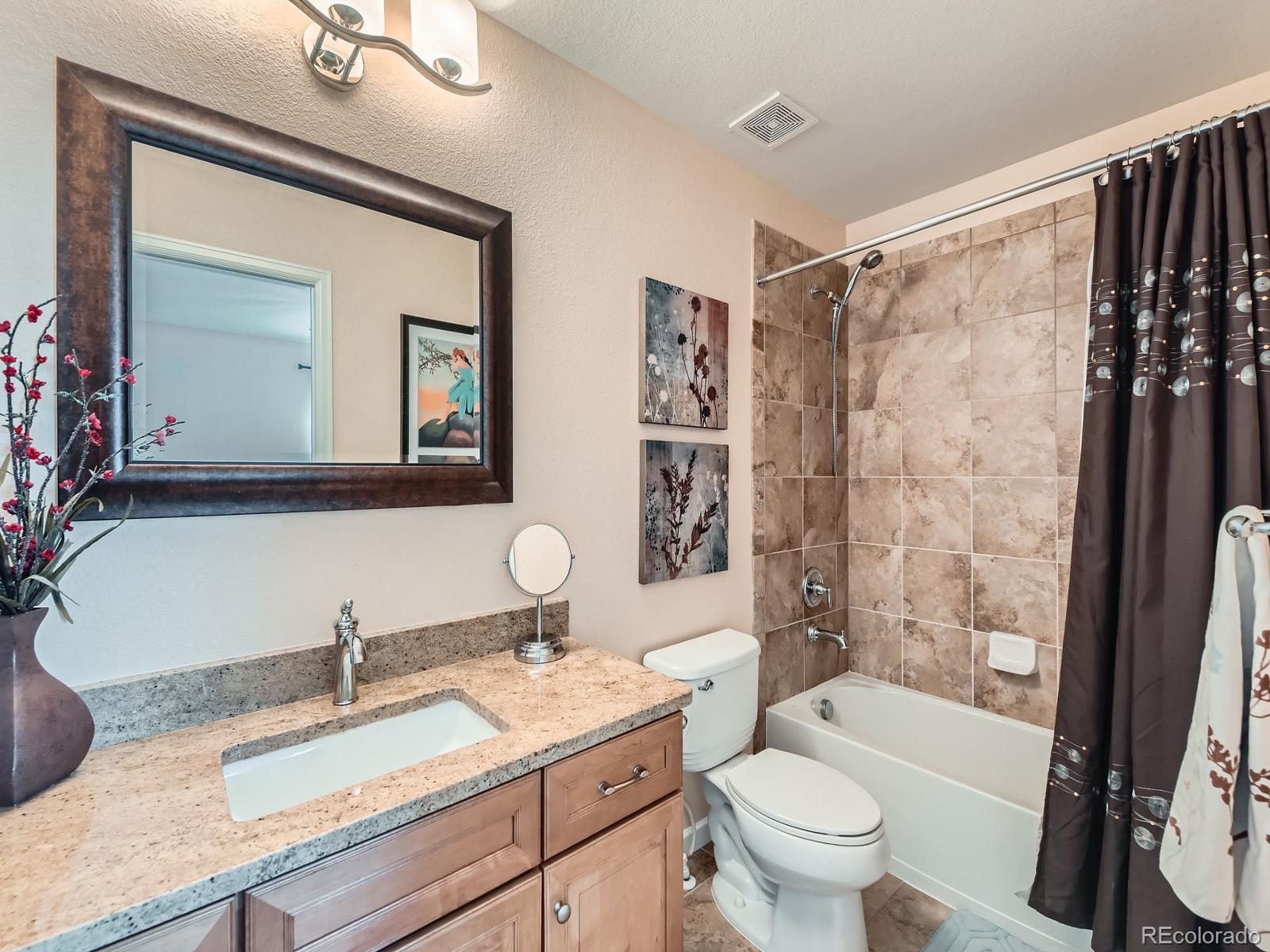 2896 Gemini Loop Broomfield, CO 80023 - Photo 24 of 49 a bathroom with a granite countertop sink toilet a large mirror and shower