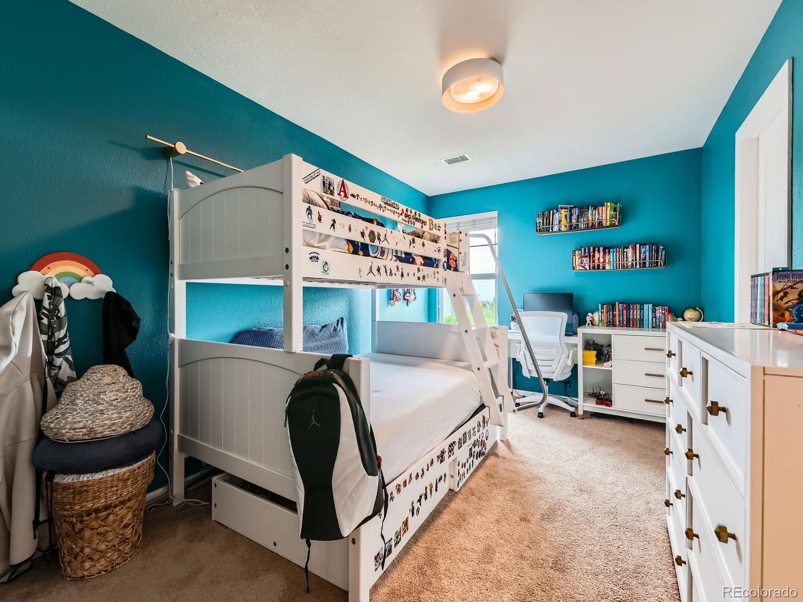 2896 Gemini Loop Broomfield, CO 80023 - Photo 25 of 49 a bedroom with a bed and a chandelier