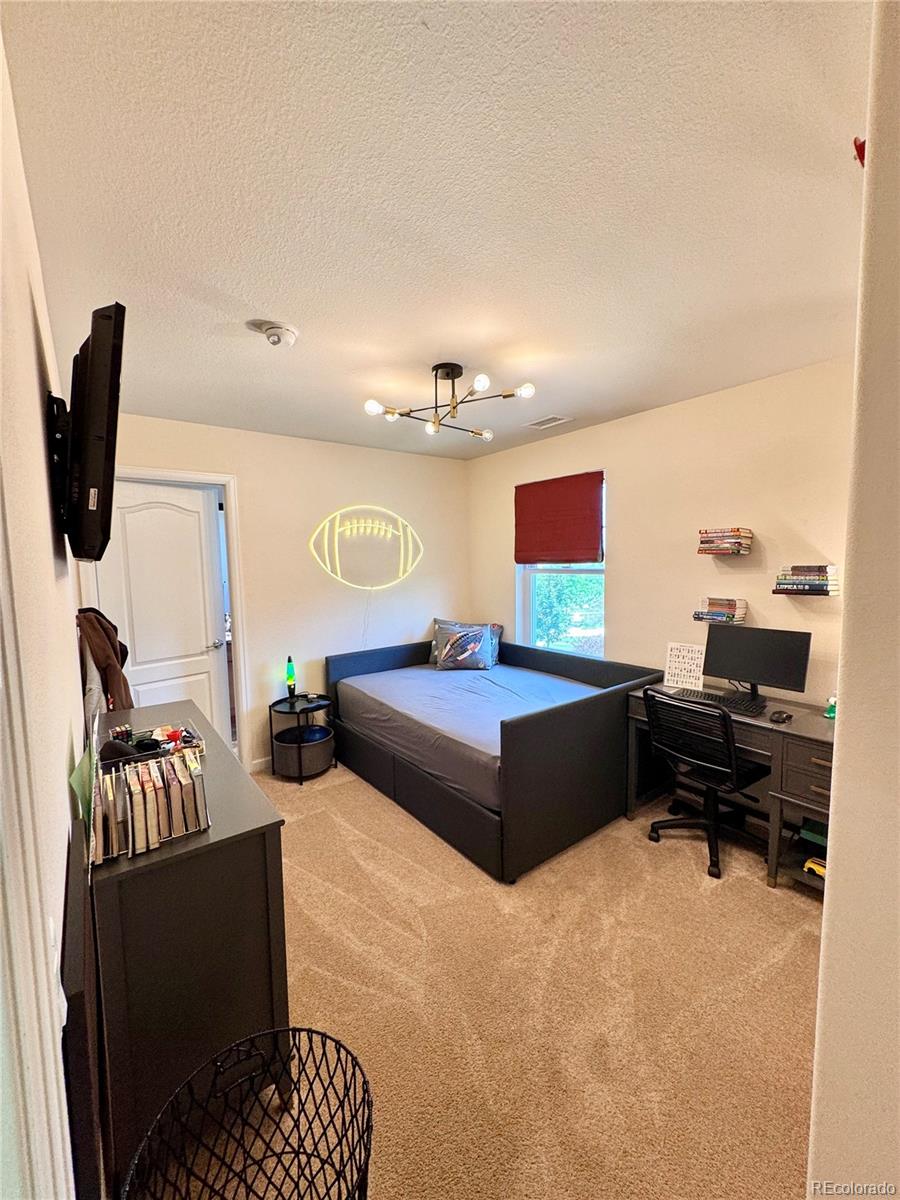 2896 Gemini Loop Broomfield, CO 80023 - Photo 27 of 49 a bedroom with furniture and a window